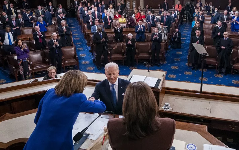 US President Joe Biden shakes hands with Speaker of the House Nancy Pelosi and Vice President Kamala Harris at the conclusion of his State of the Union address before a joint session of Congress in the United States House of Representatives chamber on Capitol Hill in Washington, DC, on March 1, 2022. (Photo by SHAWN THEW / POOL / AFP)