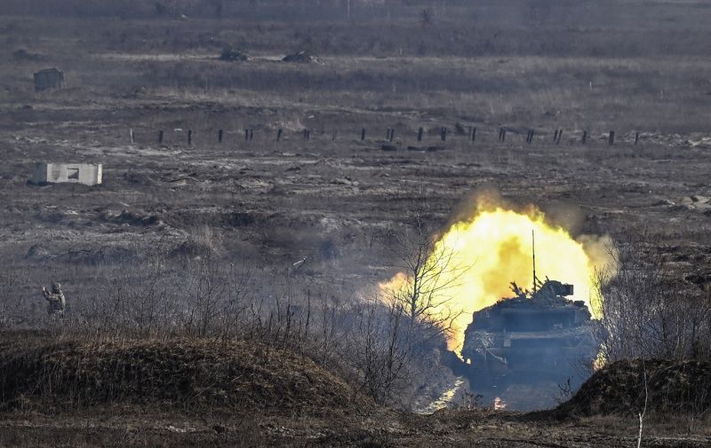 An Ukrainian Army T-64 tanks firing during a military drill outside the city of Rivne, northern Ukraine, on February 16, 2022. (Photo by Aris Messinis / AFP)