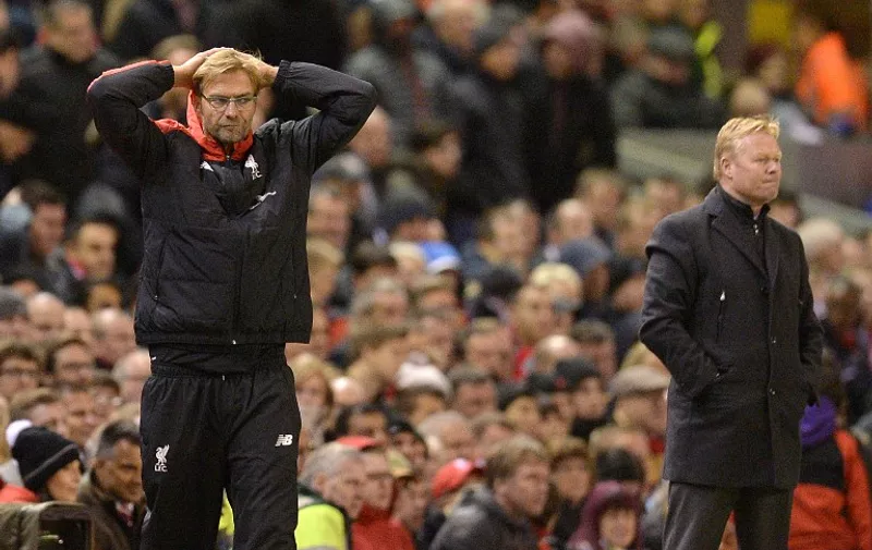 Liverpool's German manager Jurgen Klopp (L) reacts on the touchline as Southampton's Dutch manager Ronald Koeman (R) looks on during the English Premier League football match between Liverpool and Southampton at Anfield stadium in Liverpool, north west England on October 25, 2015. The game finished 1-1. AFP PHOTO / OLI SCARFF

RESTRICTED TO EDITORIAL USE. No use with unauthorized audio, video, data, fixture lists, club/league logos or 'live' services. Online in-match use limited to 75 images, no video emulation. No use in betting, games or single club/league/player publications.