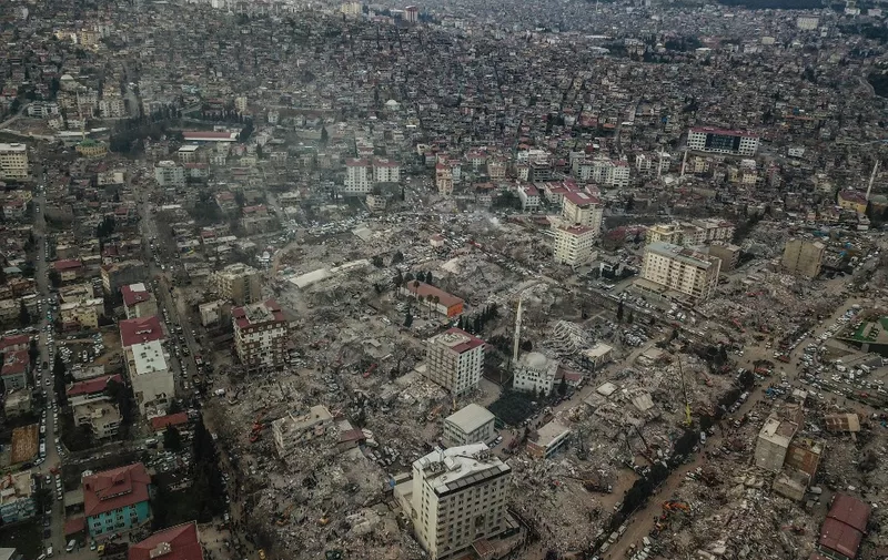 This aerial view shows collapsed buildings during the ongoing rescue operation in Kahramanmaras, the epicentre of the first 7.8-magnitude tremor five days ago, in southeastern Turkey, on February 10, 2023. - Rescuers pull children out from the rubble of the Turkey-Syria earthquake as the toll approaches 23,000 and a winter freeze compounds the suffering for nearly one million people estimated to be in urgent need of food. (Photo by OZAN KOSE / AFP)