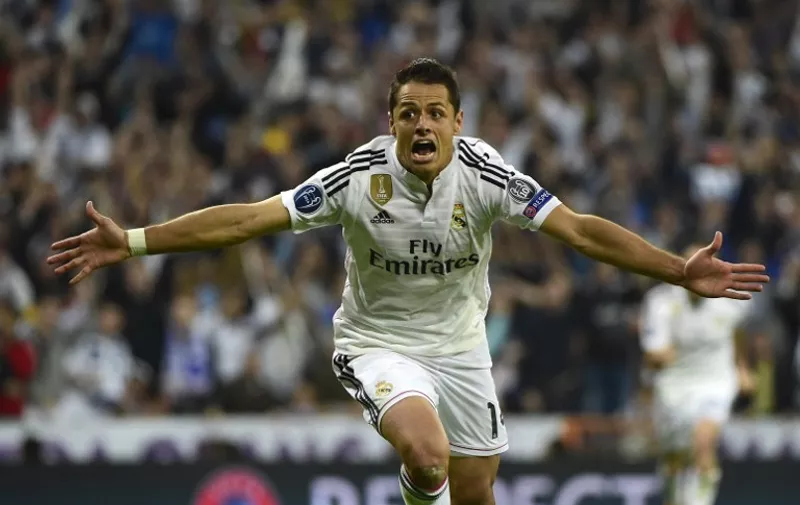 Real Madrid&#8217;s Mexican forward celebrates after scoring a goal during the UEFA Champions League quarter-finals second leg football match Real Madrid CF vs Club Atletico de Madrid at the Santiago Bernabeu stadium in Madrid on April 22, 2015. AFP PHOTO /