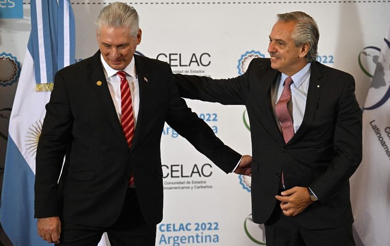 Argentine President Alberto Fernandez (R) receives Cuban President Miguel Diaz-Canel (L) before the opening of the Community of Latin American and Caribbean States (CELAC) summit in Buenos Aires, on January 24, 2023. Fifteen Latin American heads of state and government meet Tuesday in Buenos Aires for a regional summit welcoming back Brazil as President Luiz Inacio Lula da Silva looks to rebuild bridges after his far-right predecessor Jair Bolsonaro pulled out of the grouping. (Photo by Luis ROBAYO / AFP)