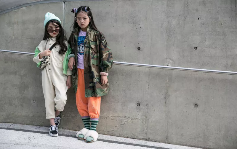 SEOUL, SOUTH KOREA - OCTOBER 17: Children are seen wearing white jumpsuit, camouflage jacket during the Seoul Fashion Week 2020 S/S at Dongdaemun Design Plaza on October 17, 2019 in Seoul, South Korea. (Photo by Jean Chung/Getty Images)