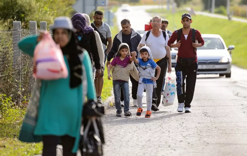 Migrants walk on the Croatian side of the Slovenska vas-Bregana border crossing between Croatia and Slovenia on September 18, 2015. Land routes to northern Europe from the Balkans were all but closed to migrants, after country after country closed their borders to an unprecedented human wave. The crisis, challenging the EU's humanitarian reputation and its vaunted policy of border mobility, has triggered an extraordinary summit, bringing leaders of the 28-nation bloc together next week. AFP PHOTO / JURE MAKOVEC