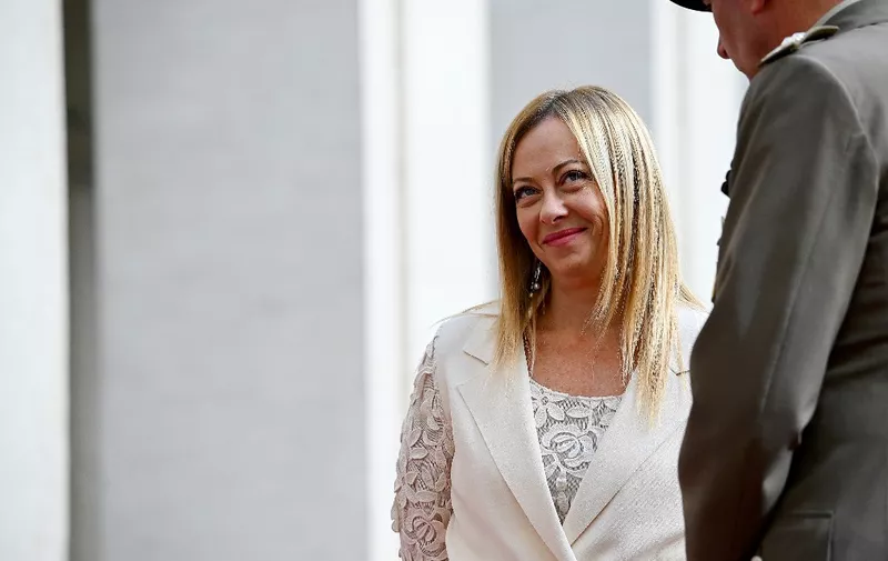 Italian Prime Minister Giorgia Meloni (L), smiles as she waits for Bahrain's King prior to their meeting at Palazzo Chigi in Rome on October 17, 2023. (Photo by Filippo MONTEFORTE / AFP)