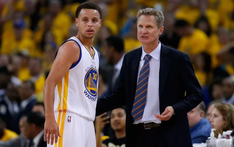 OAKLAND, CA - MAY 03: Head coach Steve Kerr of the Golden State Warriors talks to Stephen Curry #30 during their game against the Memphis Grizzlies during Game One of the Western Conference Semifinals during the NBA Playoffs on May 3, 2015 at Oracle Arena in Oakland, California. NOTE TO USER: User expressly acknowledges and agrees that, by downloading and or using this photograph, User is consenting to the terms and conditions of the Getty Images License Agreement.   Ezra Shaw/Getty Images/AFP