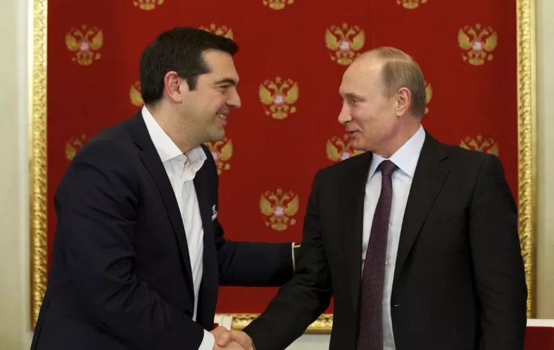 Greek Prime Minister Alexis Tsipras (L) shakes hands with Russian President Vladimir Putin during a signing ceremony at the Kremlin in Moscow on April 8, 2015. AFP PHOTO / POOL / ALEXANDER ZEMLIANICHENKO