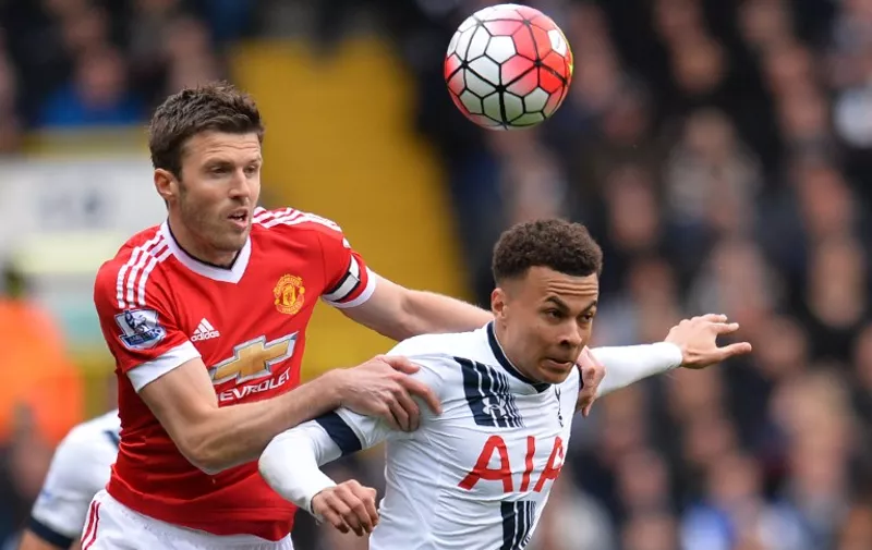 Manchester United's English midfielder Michael Carrick (L) vies with Tottenham Hotspur's English midfielder Dele Alli during the English Premier League football match between Tottenham Hotspur and Manchester United at White Hart Lane in London, on April 10, 2016. / AFP PHOTO / GLYN KIRK / RESTRICTED TO EDITORIAL USE. No use with unauthorized audio, video, data, fixture lists, club/league logos or 'live' services. Online in-match use limited to 75 images, no video emulation. No use in betting, games or single club/league/player publications.  /