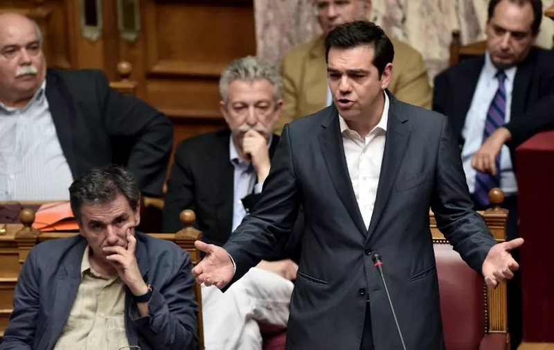 Greek Prime Minister Alexis Tsipras (R) addresses a parliamentary session in Athens on July 15, 2015. AFP PHOTO / ARIS MESSINIS