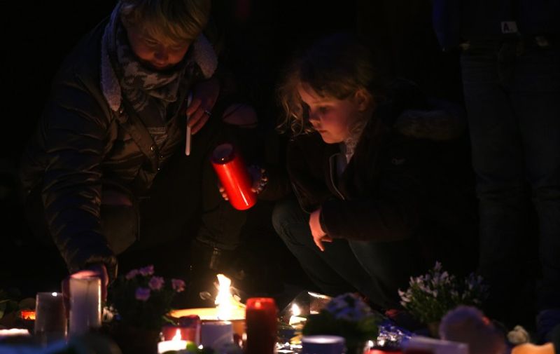 People light candles to pay tribute to the victims of the Brussels attacks on the Place de la Bourse (Beursplein) in central Brussels, on March 25, 2016, three days after a triple bomb attack, which responsibility was claimed by the Islamic State group, hit Brussels' airport and the Maelbeek - Maalbeek subway station, killing 31 people and wounding 300 others.

A grieving Belgium hunted two fugitive suspects after bombings that struck at the very heart of Europe, as security authorities faced mounting criticism over the country's worst-ever attacks. / AFP / PATRIK STOLLARZ