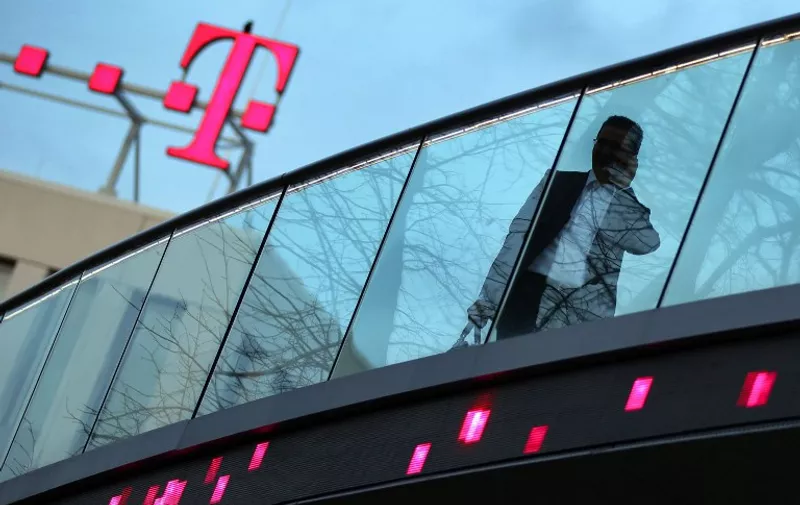 View taken on November 3, 2010 shows a man walking past the headquarters of German telecommunications giant Deutsche Telekom in Bonn, western Germany. German telecommunications operator Deutsche Telekom posted third quarter results on November 4, 2010 that disappointed investors while underscoring the effect of smartphones like Apple's iPhone on earnings. Deutsche Telekom reaffirmed its underlying operating profit target for 2010 thanks in part to stronger domestic revenues and reported a 7.9-percent rise in quarterly net profit to 1.035 billion euros (1.46 billion dollars).     AFP PHOTO / OLIVER BERG       GERMANY OUT / AFP / DPA / OLIVER BERG