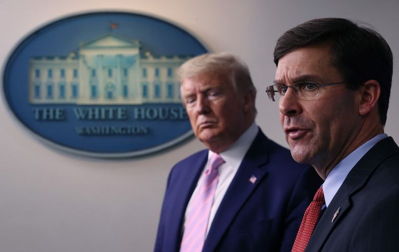 WASHINGTON, DC - APRIL 01: Secretary of Defense Mark Esper speaks as U.S. President Donald Trump listens during the daily White House coronavirus press briefing April 1, 2020 in Washington, DC. After announcing yesterday that COVID-19 could kill between 100,000 and 240,000 Americans, the Trump administration is also contending with the economic effects of the outbreak as the stock market continues to fall, businesses remain closed, and companies lay off and furlough employees.   Win McNamee/Getty Images/AFP