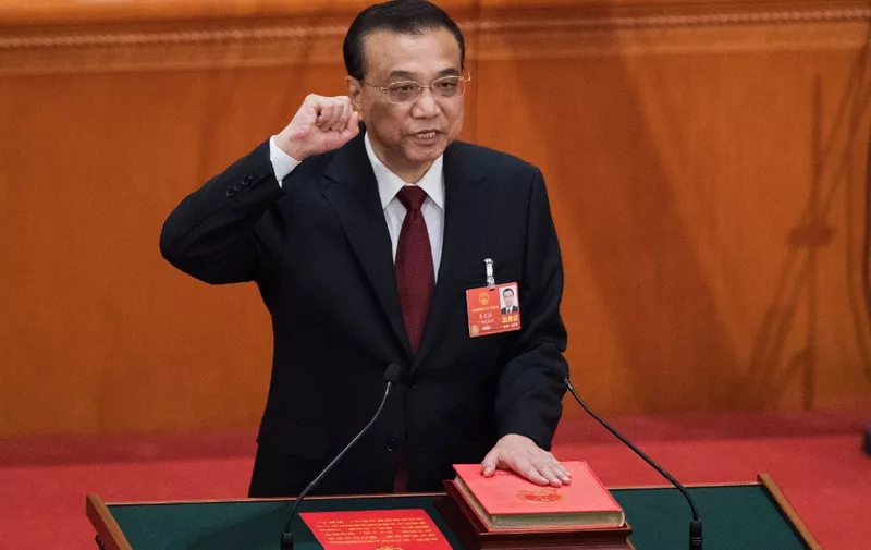 (FILES) China's Premier Li Keqiang takes an oath after he was re-elected for a second term during the sixth plenary session of the National People's Congress (NPC) at the Great Hall of the People in Beijing on March 18, 2018. Former Chinese premier Li Keqiang has died after suffering a heart attack, state media reported on October 27, 2023. (Photo by NICOLAS ASFOURI / AFP)