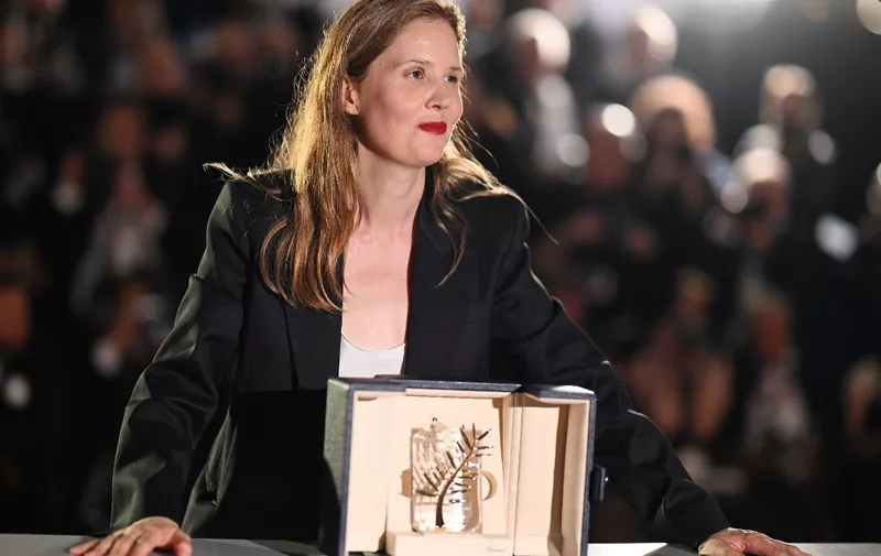 French director Justine Triet poses with the trophy during a photocall after she won the Palme d'Or for the film "Anatomie d'une Chute" (Anatomy of a Fall) during the closing ceremony of the 76th edition of the Cannes Film Festival in Cannes, southern France, on May 27, 2023. (Photo by Patricia DE MELO MOREIRA / AFP)