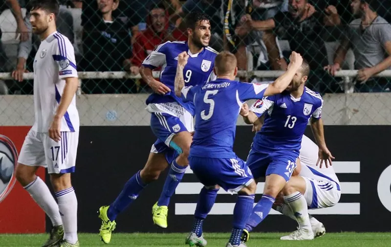 Cyprus' Nestor Mytidis (L) celebrates after scoring a goal during the Euro 2016 qualifying football match against Bosnia and Herzegovina on October 13, 2015 in Nicosia. 