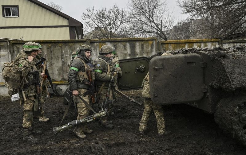 Ukrainian servicemen prepare to move towards the front line near the city of Bakhmut, on March 8, 2023, amid the Russian invasion of Ukraine. (Photo by Aris Messinis / AFP)