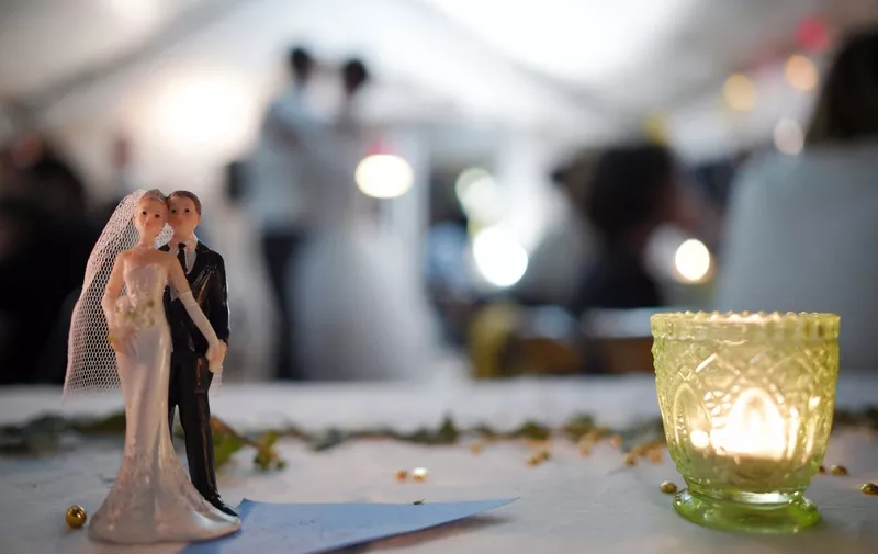 Bride and groom figurines are pictured on a table during a wedding party on september 13, 2014  in Hede-Bazouges, a suburb of Rennes, western France  AFP PHOTO / DAMIEN MEYER (Photo by DAMIEN MEYER / AFP)