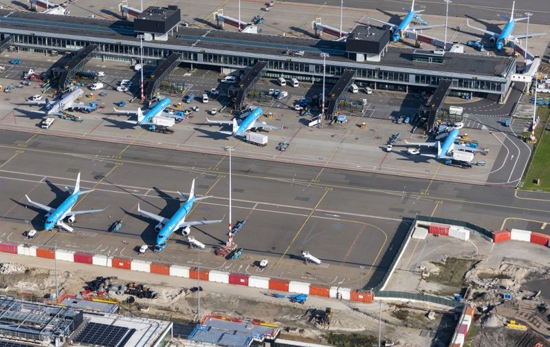 This aerial view taken on October 29, 2021, shows parked plane on the tarmac at Schiphol airport, near Amsterdam. (Photo by ARTHUR VAN DER KOOIJ / ANP / AFP) / Netherlands OUT