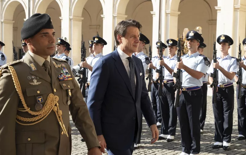 This photo taken and handout on August 29, 2019 by the Quirinale Presidential Press office shows Italys outgoing Prime Minister Giuseppe Conte arrivingh at the Quirinal presidential palace in Rome, on August 28, 2019 for a meeting with the Italian president. - Italy's anti-establishment Five Star Movement and the centre-left Democratic Party clinched a deal on August 28 to form a new government and stave off elections in the eurozone's third largest economy, though some uncertainties remained. (Photo by Handout / Quirinale Press Office / AFP) / RESTRICTED TO EDITORIAL USE - MANDATORY CREDIT "AFP PHOTO / QUIRINALE PRESIDENTIAL PRESS OFFICE" - NO MARKETING NO ADVERTISING CAMPAIGNS - DISTRIBUTED AS A SERVICE TO CLIENTS ---
