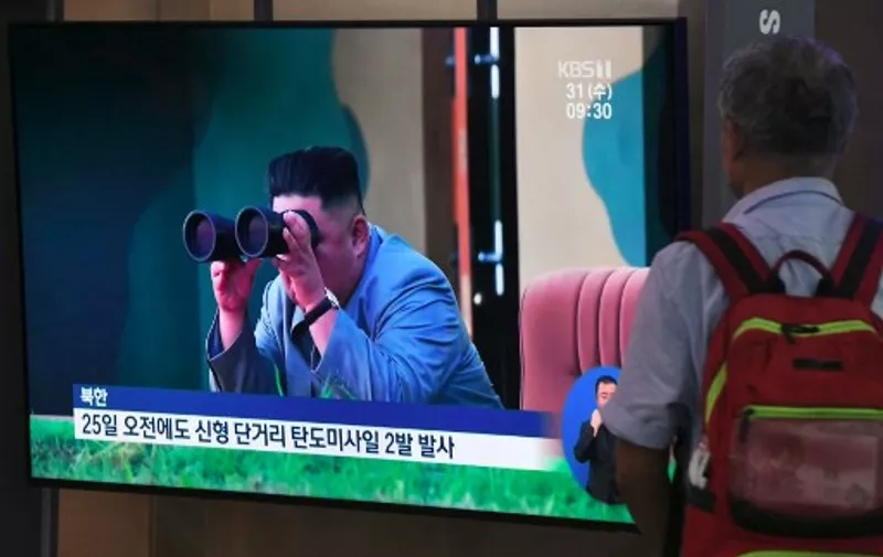 A man watches a television news screen showing file footage of North Korean leader Kim Jong Un watching a missile launch, at a railway station in Seoul on July 31, 2019. - Pyongyang fired two ballistic missiles on July 31, Seoul said, days after a similar launch that the nuclear-armed North described as a warning to the South over planned joint military drills with the United States. (Photo by Jung Yeon-je / AFP)