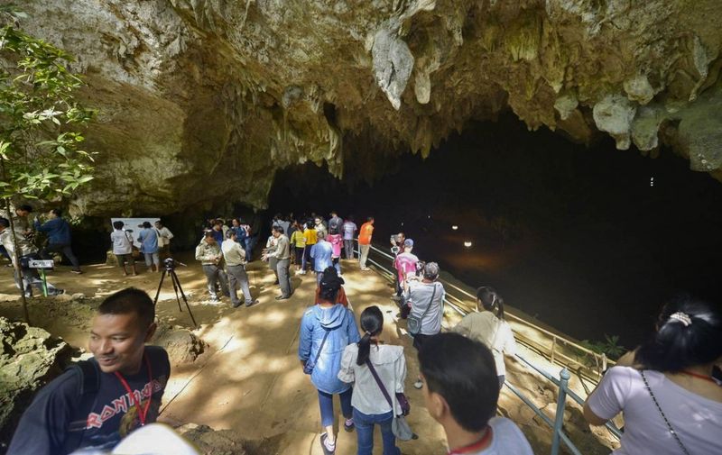 This handout photo taken on November 1, 2019 and released by Department of National Parks, Wildlife and Plant Conservation shows people visiting Tham Luang cave in the Mae Sai district of Thailand's northern Chiang Rai province. - Thailand reopened the cave on November 1 where 12 young footballers and their coach were trapped last year in a saga that captivated the world. (Photo by Handout / various sources / AFP) / RESTRICTED TO EDITORIAL USE - MANDATORY CREDIT "AFP PHOTO / Department of National Parks, Wildlife and Plant Conservation" - NO MARKETING NO ADVERTISING CAMPAIGNS - DISTRIBUTED AS A SERVICE TO CLIENTS
