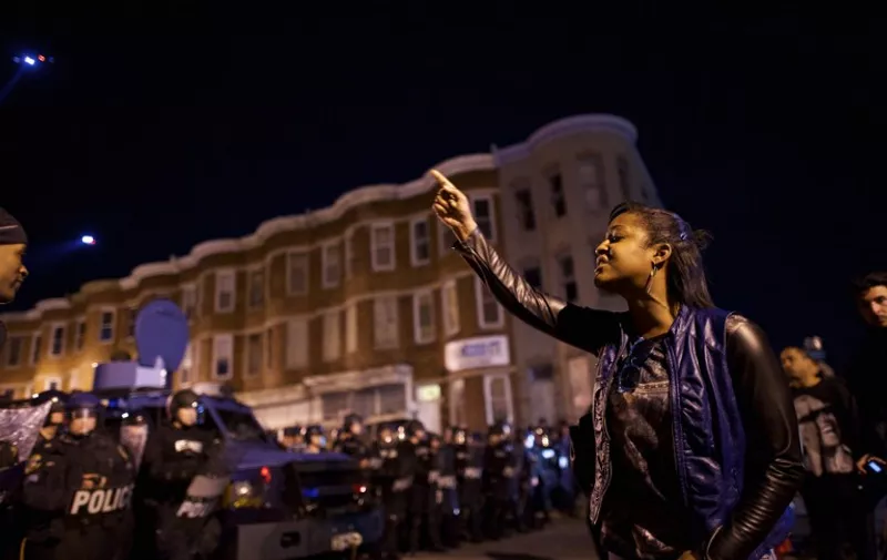 BALTIMORE, MD - APRIL 28: Protestors taunt police officers the night after citywide riots over the death of Freddie Gray on April 28, 2015 in Baltimore, Maryland. Freddie Gray, 25, was arrested for possessing a switch blade knife April 12 outside the Gilmor Houses housing project on Baltimore's west side. According to his attorney, Gray died a week later in the hospital from a severe spinal cord injury he received while in police custody.   Mark Makela/Getty Images/AFP