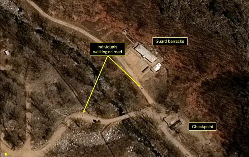 This handout picture obtained on April 13, 2017 from French space agency Centre national d'etudes spatiales (CNES - National Centre for Space Studies), Airbus Defense and Space and the 38 North analysis group, shows a satellite image taken on April 12, 2017 of North Korea's Punggye-ri Nuclear Test Site, with individuals seen walking near the guard barracks and security checkpoint.
North Korea is ready to launch a nuclear test at its Punggye-ri Nuclear Test Site, the 38 North monitoring group reported on April 12, 2017. "Commercial satellite imagery of North Koreas Punggye-ri Nuclear Test Site from April 12 shows continued activity around the North Portal, new activity in the Main Administrative Area, and a few personnel around the sites Command Center," the North Korea-related analysis website said.  / AFP PHOTO / CNES AND Airbus Defense &amp; Space and 38 North / HO / RESTRICTED TO EDITORIAL USE - MANDATORY CREDIT "AFP PHOTO / CNES / Airbus Defense and Space / 38 North" - NO MARKETING NO ADVERTISING CAMPAIGNS - DISTRIBUTED AS A SERVICE TO CLIENTS