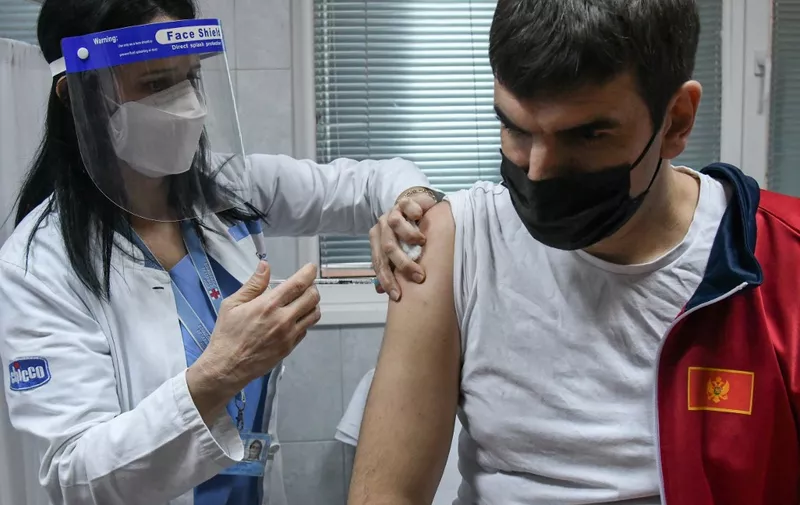 A man receives a dose of Russian-made Sputnik V Covid-19 vaccine in Podgorica on February 22, 2021. (Photo by SAVO PRELEVIC / AFP)