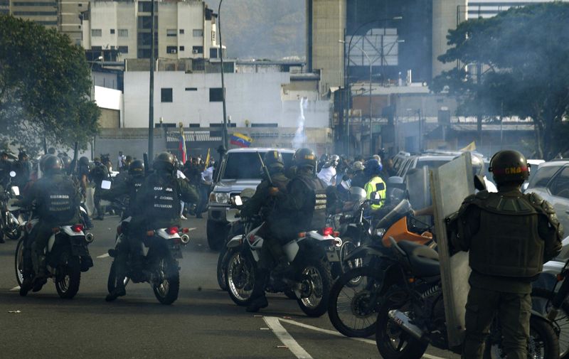 Members of the Bolivarian National Guard loyal to Venezuelan President Nicolas Maduro who arrived to disperse demonstrators are being repelled by guards who joined supporting Venezuelan opposition leader and self-proclaimed acting president Juan Guaido, in front of La Carlota military base in Caracas on April 30, 2019. Guaido said on Tuesday that troops had joined his campaign to oust President Nicolas Maduro as the government vowed to put down what it called an attempted coup., Image: 429900965, License: Rights-managed, Restrictions: , Model Release: no, Credit line: Profimedia, AFP