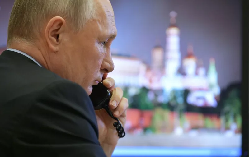 Russian President Vladimir Putin attends a meeting on the situation with the spread of the COVID-19 coronavirus disease in Russia, via a teleconference call at the Novo-Ogaryovo state residence outside Moscow on April 13, 2020. (Photo by Alexey DRUZHININ / SPUTNIK / AFP)