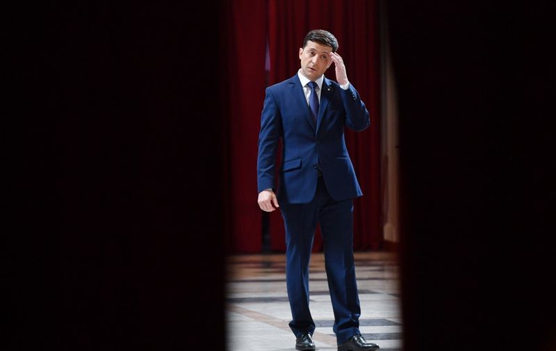 Ukrainian comic actor, showman and presidential candidate Volodymyr Zelensky rests while taking part in the shooting of the television series "Servant of the People" where he plays the role of the President of Ukraine, in Kiev on March 6, 2019. - Anger with the political elite is partly behind the rise of Volodymyr Zelensky, a TV actor with no political experience who is the frontrunner in the upcoming presidential vote.  Zelensky is polling at 25 percent, ahead of Poroshenko on 17 percent and former prime minister Yulia Tymoshenko on 16 percent as of March 4, 2019. (Photo by Sergei SUPINSKY / AFP)