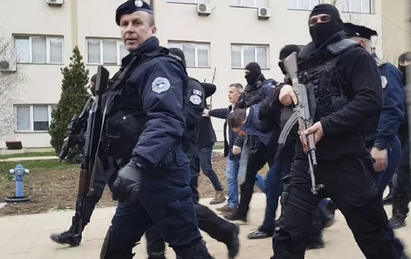 This still image from video shows Kosovo police escorting senior Serbian official Marko Djuric (C) near the police station in Pristina on March 26, 2018. 
Kosovo police on March 26th arrested a senior Serbian official after he crossed into the disputed territory and traveled to the flashpoint town of Mitrovica in defiance of a ban, a police spokesman said. Marko Djuric, Belgrade's chief negotiator for the former Serbian province that proclaimed independence in 2008, "was arrested and we are taking him to a police centre in Pristina," spokesman Baki Kelani said. / AFP PHOTO / AFP TV