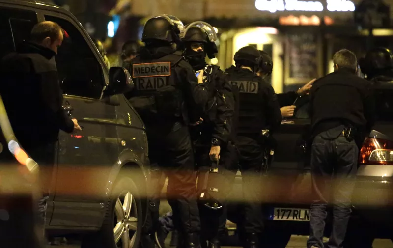Police officers man a position close to the Bataclan theatre on November 13, 2015 after a series of gun attacks occurred across Paris as well as explosions outside the national stadium where France was hosting Germany. A number of people were killed and others injured in a series of gun attacks across Paris on Friday, as well as explosions outside the national stadium where France was hosting Germany.  AFP PHOTO /KENZO TRIBOUILLARD        (Photo credit should read KENZO TRIBOUILLARD/AFP/Getty Images)