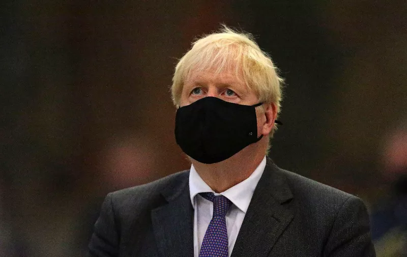 Britain's Prime Minister Boris Johnson wearing a protective face covering, attends a service marking the 80th anniversary of the Battle of Britain at Westminster Abbey in central London on September 20, 2020. - Westminster Abbey has played a central role in remembering the sacrifice of those who fought in the battle, holding a Service of Thanksgiving and Rededication on Battle of Britain Sunday every year since 1944. (Photo by Aaron Chown / POOL / AFP)