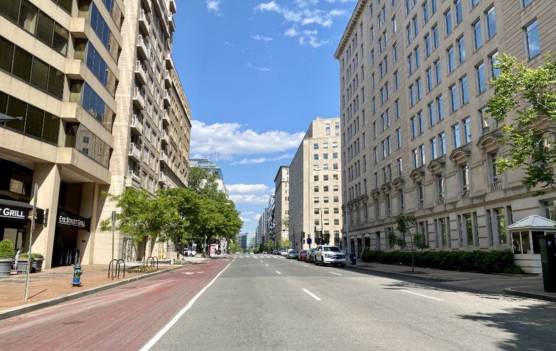 A street in downtown Washington, DC is seen empty on May 13, 2020 amid the coronavirus pandemic as the stay-at-home order has been extended for the nation's capital until June 9. (Photo by Daniel SLIM / AFP)