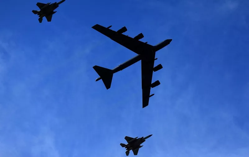 BATON ROUGE, LOUISIANA - OCTOBER 16: A Boeing B-52 Stratofortress is escorted by two McDonnell Douglas F-15 Eagles during a fly-over before a game between the LSU Tigers and the Florida Gators at Tiger Stadium on October 16, 2021 in Baton Rouge, Louisiana.   Jonathan Bachman/Getty Images/AFP (Photo by Jonathan Bachman / GETTY IMAGES NORTH AMERICA / Getty Images via AFP)