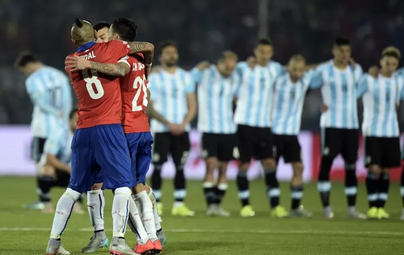 TOPSHOTS
Chile's midfielder Arturo Vidal, Chile's midfielder Charles Aranguiz and Chile's defender Gary Medel celebrate after winning the 2015 Copa America football championship, in Santiago, Chile, on July 4, 2015. Chile defeated 4-1 Argentina in the penalty shootout.    AFP PHOTO / JUAN MABROMATA