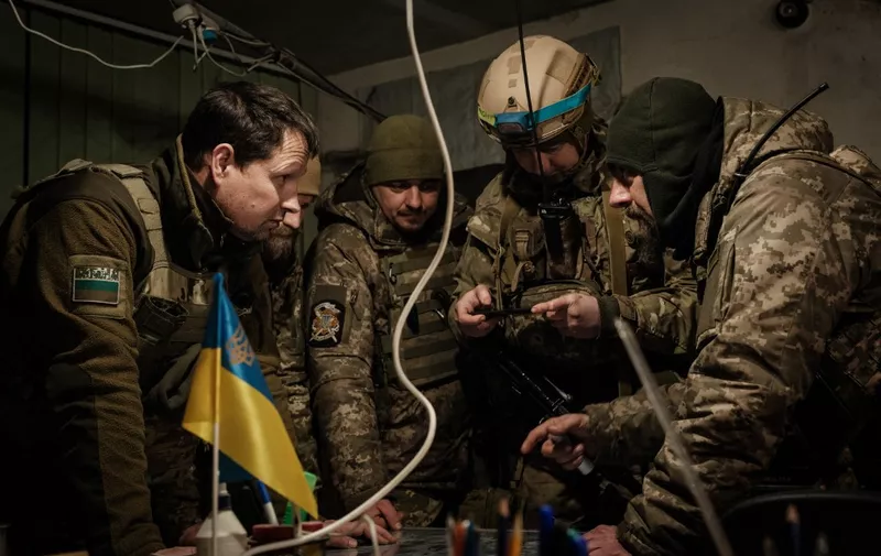 TOPSHOT - Ukrainian servicemen of the State Border Guard Service work in the operations room in Bakhmut on February 9, 2023, amid the Russian invasion of Ukraine. (Photo by YASUYOSHI CHIBA / AFP)
