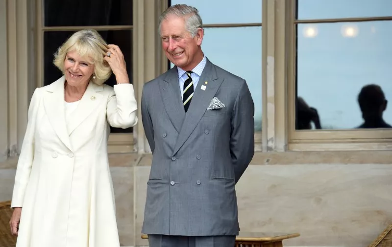 Britain's Prince Charles (R) and his wife, Camilla the Duchess of Cornwall, listen to speeches during a reception at Government House in Sydney on November 12, 2015.  Prince Charles and his wife Camilla are on a two-week tour of New Zealand and Australia.  AFP PHOTO / POOL / AFP / POOL / PAUL MILLER