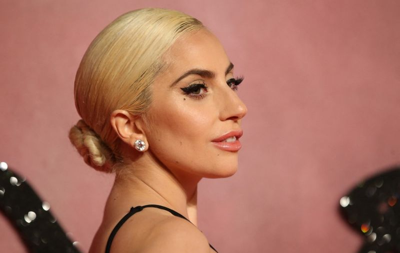 US singer Lady Gaga poses on the red carpet upon arrival to attend the British Fashion Awards 2016 in London on December 5, 2016. (Photo by Daniel LEAL-OLIVAS / AFP)