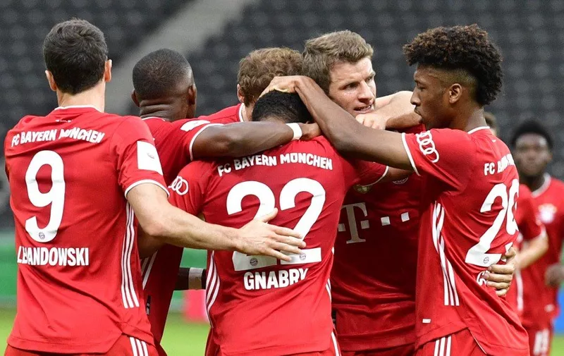 Bayern Munich's German midfielder Serge Gnabry (C) celebrates scoring his team's second goal with team mates during the German Cup (DFB Pokal) final football match Bayer 04 Leverkusen v FC Bayern Munich at the Olympic Stadium in Berlin on July 4, 2020. (Photo by John MACDOUGALL / various sources / AFP) / DFB REGULATIONS PROHIBIT ANY USE OF PHOTOGRAPHS AS IMAGE SEQUENCES AND QUASI-VIDEO.