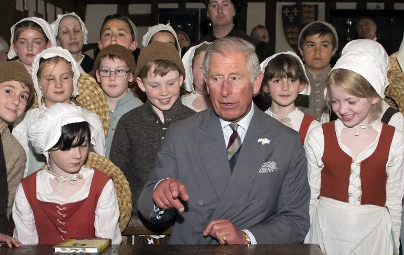 Britain's Prince Charles, Prince of Wales and President of The Royal Shakespeare Company, speaks with students and teachers dressed in costumes during his visit to the King Edward VI School, where William Shakespeare is believed to have studied, in Church Street, Stratford-upon-Avon, Warwickshire on June 2, 2014. AFP PHOTO/POOL/PAUL EDWARDS / AFP PHOTO / POOL / PAUL EDWARDS