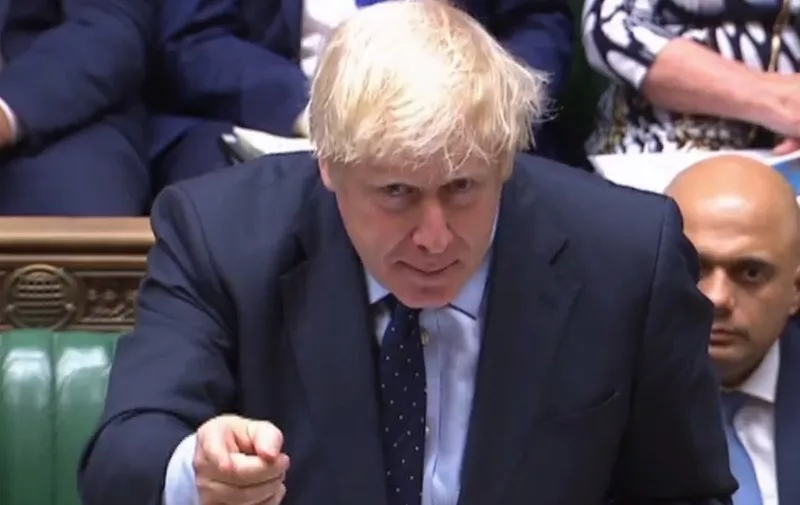 A video grab from footage broadcast by the UK Parliament's Parliamentary Recording Unit (PRU) shows Britain's Prime Minister Boris Johnson gestures toward the opposition benches as he stands a the dispatch box and speaks in the House of Commons in London on September 3, 2019, as he gives a statement on the recent G7 meeting. - Prime Minister Boris Johnson was braced for a showdown with parliament on Tuesday over his Brexit plan that could spark a snap election and derail Britain's exit from the European Union next month. (Photo by - / various sources / AFP) / RESTRICTED TO EDITORIAL USE - MANDATORY CREDIT " AFP PHOTO / PRU " - NO USE FOR ENTERTAINMENT, SATIRICAL, MARKETING OR ADVERTISING CAMPAIGNS - EDITORS NOTE THE IMAGE HAS BEEN DIGITALLY ALTERED AT SOURCE TO OBSCURE VISIBLE DOCUMENTS