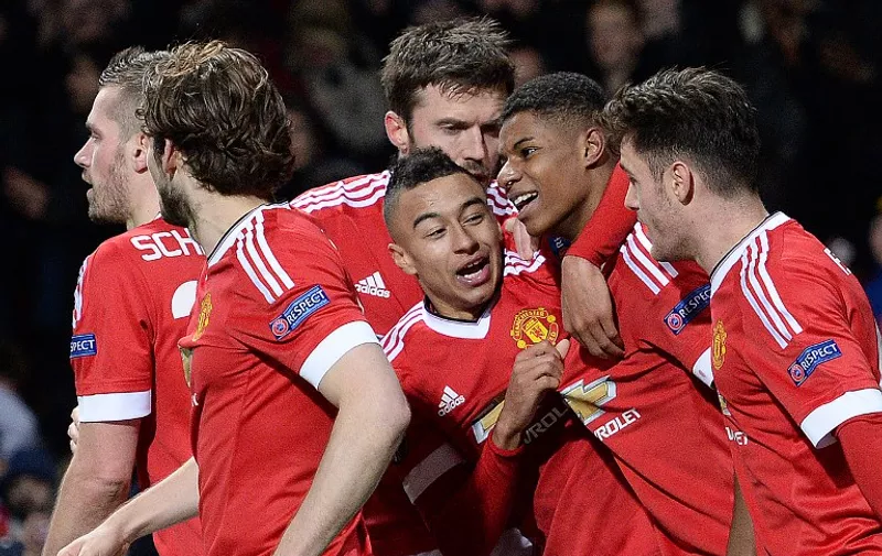 Manchester United's English striker Marcus Rashford (2R) celebrates scoring his team's third goal during the UEFA Europa League round of 32, second leg football match between Manchester United and and FC Midtjylland at Old Trafford in Manchester, north west England, on February 25, 2016. / AFP / OLI SCARFF