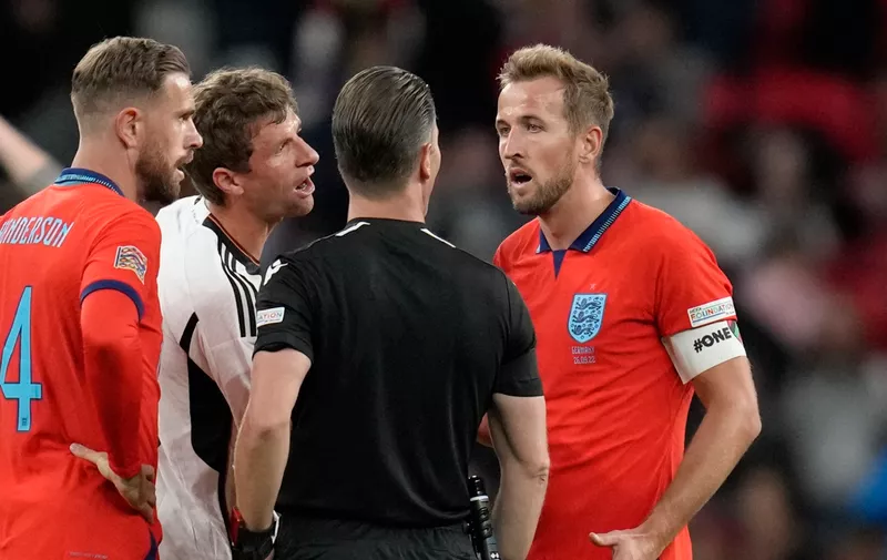 ]England's Harry Kane argues with referee Danny Makkelie at the end of the UEFA Nations League soccer match between England and Germany at Wembley stadium in London, Monday, Sept. 26, 2022. (AP Photo/Kirsty Wigglesworth)