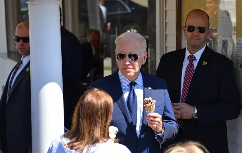 US President Joe Biden greets a woman after ordering an ice cream at Honey Hut Ice Cream in Cleveland, Ohio, on May 27, 2021. (Photo by Nicholas Kamm / AFP)