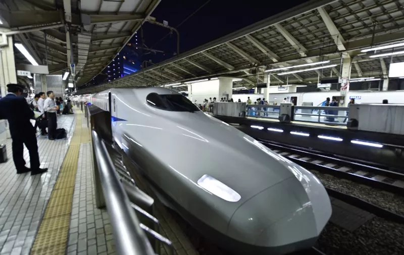 A bullet train is seen parked as passengers wait for operations to resume at a train station in Tokyo following an earthquake on May 30, 2015. A 7.8-magnitude earthquake struck off the Japanese coast May 30, geologists said, shaking buildings in Tokyo and setting off car alarms, an AFP correspondent reported.   AFP PHOTO / KAZUHIRO NOGI