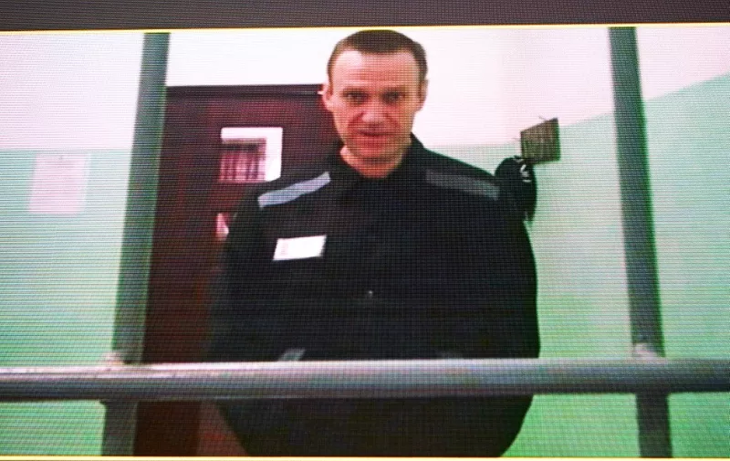 Jailed Russian opposition figure Alexei Navalny is seen on a screen via a video link from his penal colony during court hearings over the extremism criminal case against him at the Russia's Supreme Court in Moscow on June 22, 2023. A Russian court ordered on June 19, 2023, that the trial for Kremlin critic Alexei Navalny be held behind closed doors as he faces extremism charges that could see his time in prison extended for decades. The case comes more than a year into Russia's full-scale offensive in Ukraine, which unleashed an unprecedented crackdown on the Kremlin's critics, with many now in exile or in jail. President Vladimir Putin's most prominent critic is being tried at the maximum security prison where he is jailed: IK-6 penal colony, some 250 kilometres (155 miles) east of Moscow. (Photo by Natalia KOLESNIKOVA / AFP)
