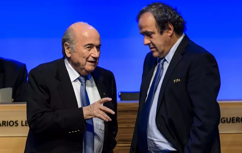 FILES - A picture taken on June 11, 2014 shows FIFA president Joseph Blatter talking to UEFA president Michel Platini during the 64th FIFA congress in Sao Paulo, on the eve of the opening match of the 2014 FIFA World Cup in Brazil. Embattled FIFA chief Joseph Blatter is suspected of "disloyal payment" to UEFA head Michel Platini, who had hoped to succeed him, the office of Switzerland's attorney general said on September 25, 2015.  AFP PHOTO / FABRICE COFFRINI