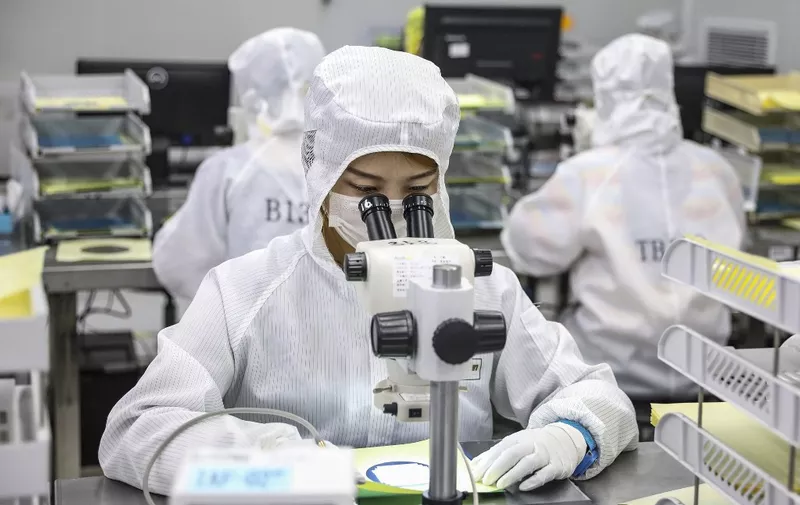 This photo taken on June 16, 2020 shows a worker producing LED chips at a factory in Huaian, in China's eastern Jiangsu province. (Photo by STR / AFP) / China OUT